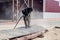 A worker in a special suit is sandblasting metal at an industrial site