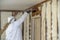 Worker spraying closed cell spray foam insulation on a home