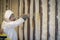 Worker spraying closed cell spray foam insulation on a home wall