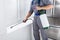 Worker Spraying Insecticide On Windowsill