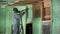 Worker spraying polyurethane foam for insulating wooden frame house.