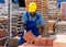 Worker stacking bricks in warehouse of building materials clpseup