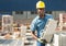 Worker stacking bricks in warehouse of building materials clpseup