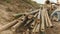 worker stacking wet bamboo poles up on the riverbank