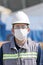 The worker staff, engineer protects himself from covid-19 coronavirus with a protective mask in the construction site.