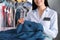 Worker with stained clothes at dry-cleaner`s, closeup