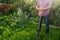 Worker standing with shovel in the garden, ready to loosen ground