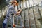 A worker standing on the stairs commutes telephone wires. The engineer works in the server room of the data center. Cable laying