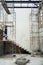 Worker stands on the steel scaffolding and plastering the cement