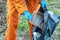 Worker in a suit collects dirty plastic in a park