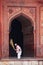 Worker sweeping courtyard of Jama Masjid in Fatehpur Sikri, Uttar Pradesh, India