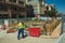 Worker sweeping the floor on construction site in Madrid