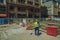 Worker sweeping the floor on construction site in Madrid