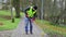 Worker sweeps leaves in the park