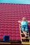 A worker takes a sun bath on the roof of the house during