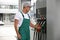 Worker taking fuel pump nozzle at modern gas station