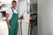 Worker taking fuel pump nozzle at modern gas station