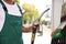 Worker taking fuel pump nozzle at modern gas station, closeup