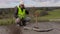 Worker talking on phone at broken concrete slabs