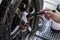 A worker thoroughly cleans the spokes of a wheel`s rim with a fine brush. During a full detail and exterior car wash