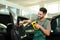 Worker tinting car window with heat gun