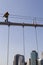 Worker on top of Brooklyn Bridge in New York City
