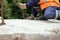 worker touches the crane hooks to the loops in the concrete slab during repair work.