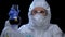 Worker of toxic lab examining flask with biohazard liquid, runoff water analysis