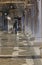 Worker with the transport cart and the boots at high tide in venice