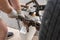 Worker trying to bend metal on a tow hitch