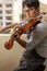 Worker tuning a violin in a repair shop