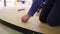 Worker twists screws assembling construction on floor