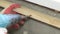 Worker twists the into wooden Board electric screwdriver, home renovations