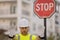 Worker in uniform gesturing stop. Serious builder with stop road sign. Builder with stop gesture, no hand, dangerous on