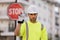 Worker in uniform gesturing stop. Serious worker with stop road sign. Builder with stop gesture, no hand, dangerous on