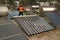 The worker in uniform and helmet checks concentrating Solar Power with Flat Plat collector and Evacuum Tube Collector.