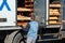 The worker unloads fresh bread from the truck