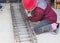 Worker used pliers wire tie tightening of steel bar reinforcement