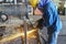 A worker uses Grinding Machine to grind the surface of the steel plate before assembling it into the steel pipe.