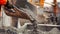 A worker uses a large mixing machine to combine aggregates cement and water for the perfect concrete mix