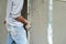 Worker uses the trowel for plastering the brickwork wall by mixed cement