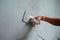 Worker uses the trowel for plastering the brickwork wall by mixed cement