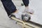 Worker using angle grinder, construction site