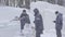 Worker using a chainsaw carving an ice sculpture. Men discuss work with ice sculptures. Workers clean the snow. Men