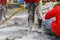 Worker using construction drilling cement on the ground