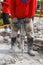 Worker using construction drilling cement on the ground