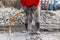 Worker using construction drilling cement on the ground