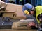 Worker using cutting wheel to slice thick paving slab.