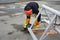 Worker using electric grinder Metal sawing with flashing sparks. The worker cuts off a piece of pipe