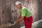 Worker using electric sander to remove old paint